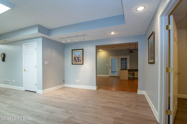 interior space with light hardwood / wood-style flooring and a textured ceiling