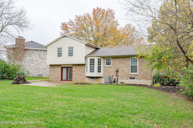 back of house featuring central air condition unit, a yard, a patio, and french doors