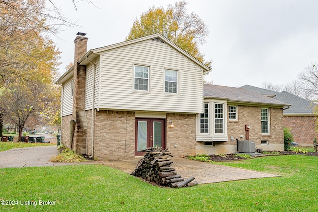 back of house with a yard, french doors, and central AC unit