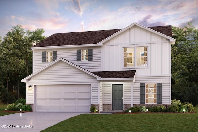 view of front of house featuring a yard and a garage