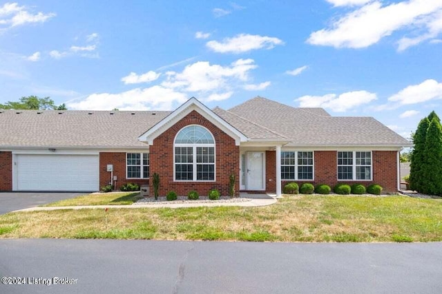 single story home featuring a garage and a front yard