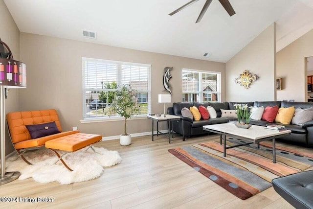 living room with light hardwood / wood-style flooring, vaulted ceiling, and ceiling fan