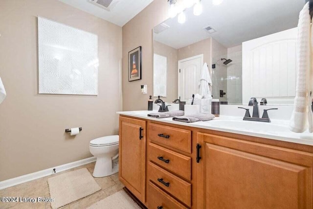 bathroom with a tile shower, tile patterned flooring, vanity, and toilet