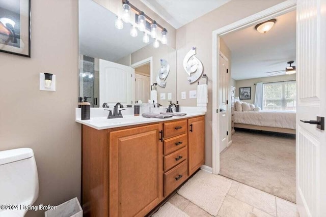 bathroom featuring vanity, toilet, and ceiling fan