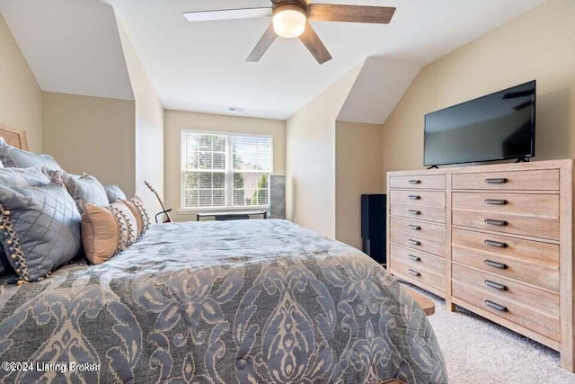 carpeted bedroom with vaulted ceiling and ceiling fan