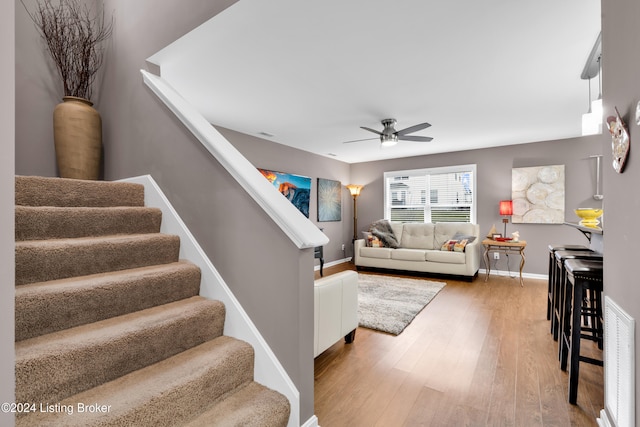 living room with hardwood / wood-style flooring and ceiling fan