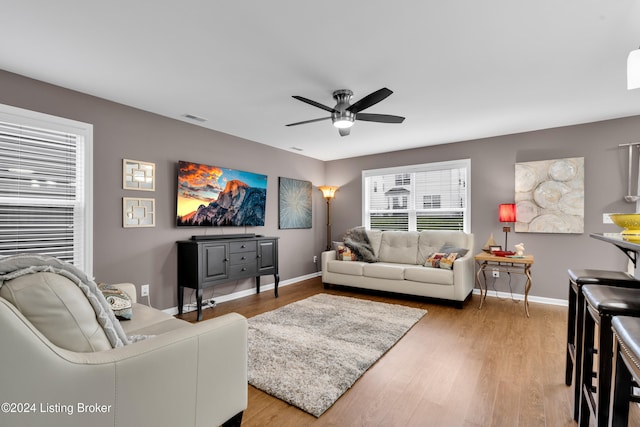 living room with hardwood / wood-style flooring and ceiling fan