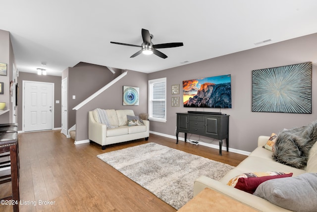 living room with hardwood / wood-style floors and ceiling fan