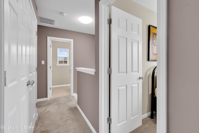 hallway featuring light carpet