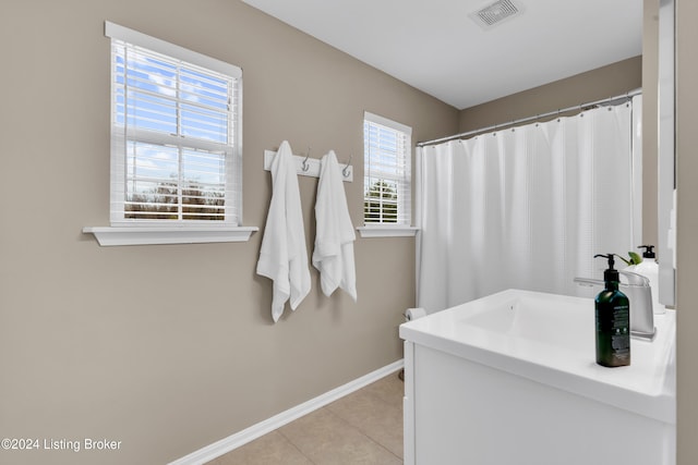 bathroom featuring tile patterned flooring, a shower with curtain, vanity, and a wealth of natural light