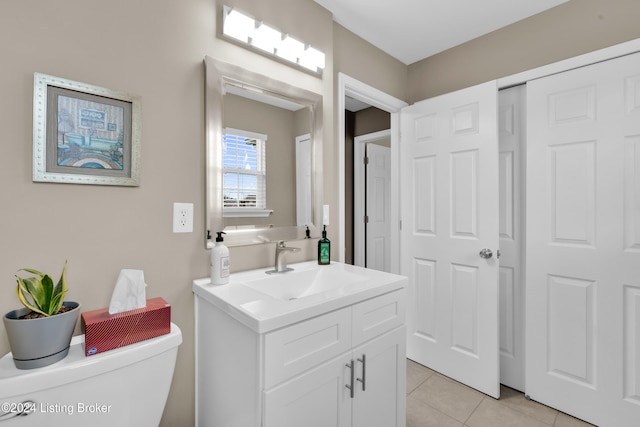 bathroom with tile patterned floors, vanity, and toilet