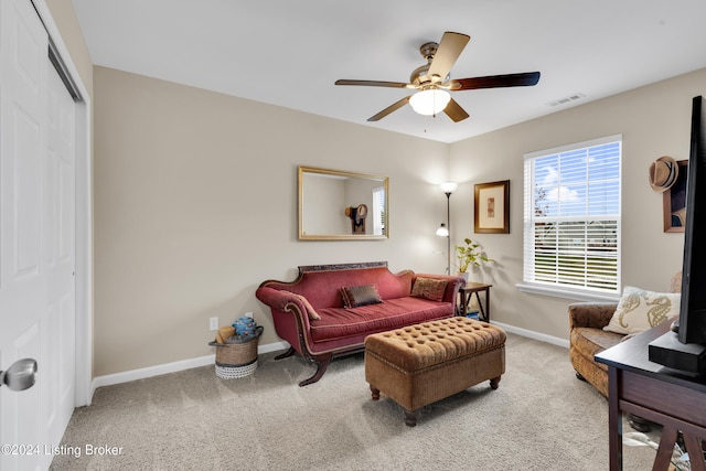 living room featuring carpet floors and ceiling fan