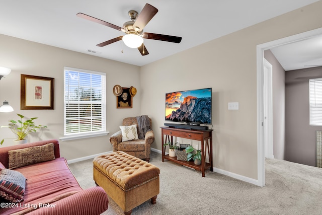 living room featuring carpet floors and ceiling fan