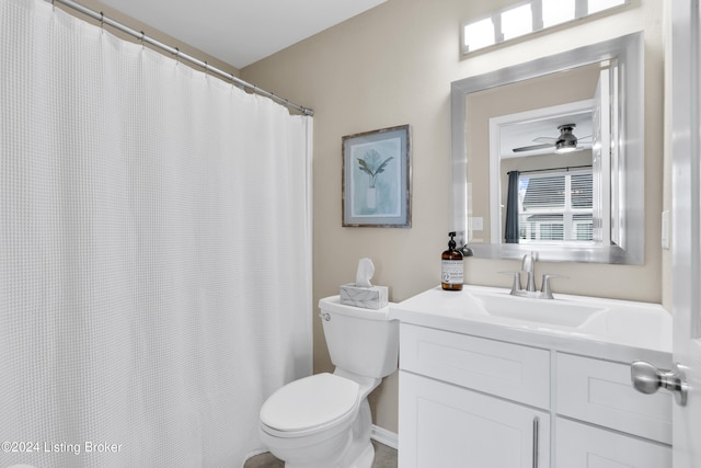 bathroom with vanity, toilet, and ceiling fan