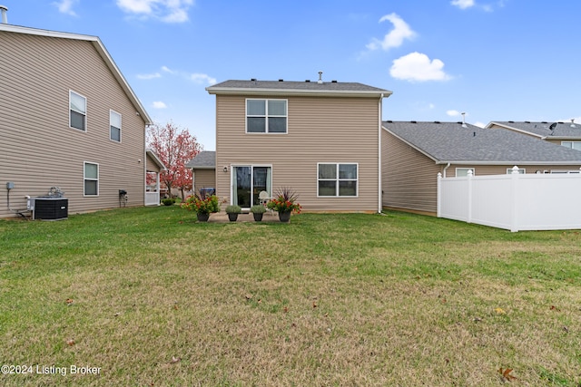 rear view of house featuring a lawn