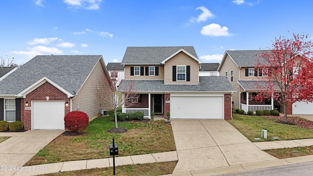 front of property with a garage, covered porch, and a front lawn