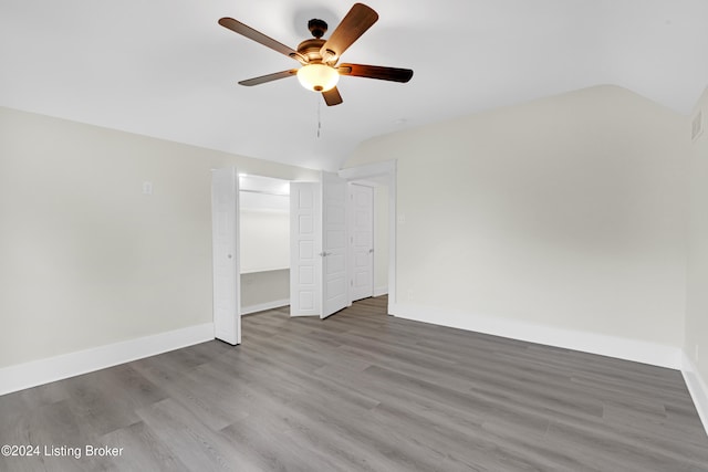 unfurnished bedroom featuring ceiling fan, hardwood / wood-style floors, and lofted ceiling