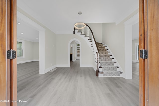 interior space featuring light hardwood / wood-style flooring and ornamental molding