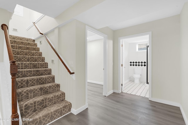 stairs with wood-type flooring