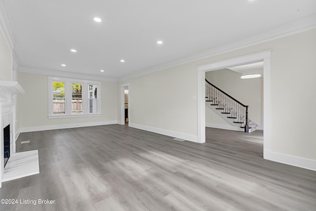 unfurnished living room with hardwood / wood-style floors and ornamental molding