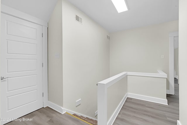 corridor featuring wood-type flooring