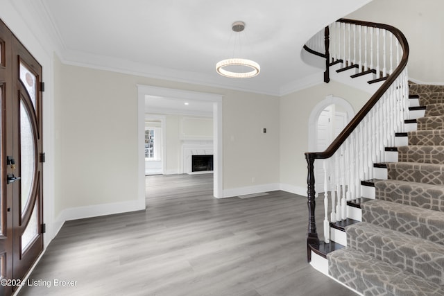 entryway featuring hardwood / wood-style floors and ornamental molding