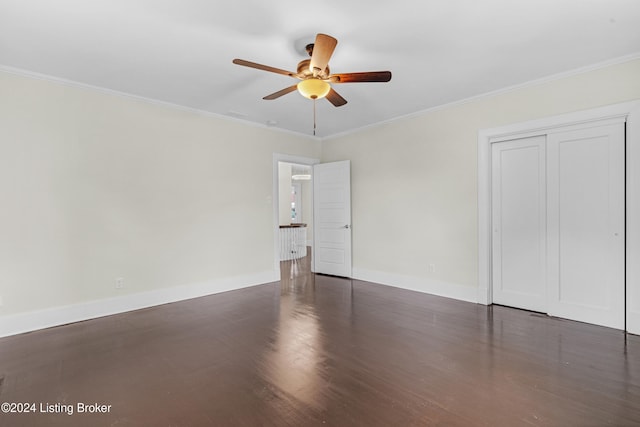 unfurnished room featuring crown molding, ceiling fan, and dark wood-type flooring