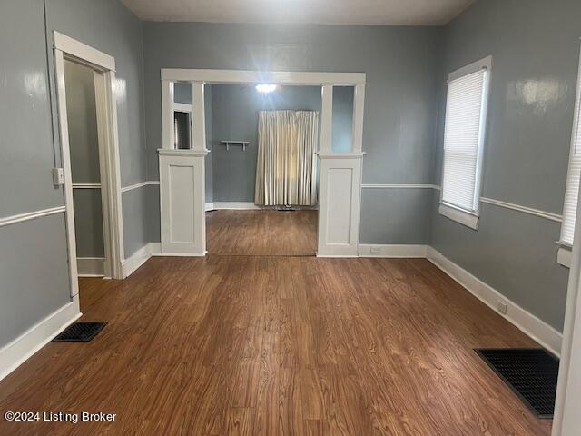 empty room with dark hardwood / wood-style floors