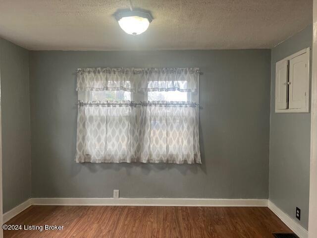 empty room featuring hardwood / wood-style floors and a textured ceiling