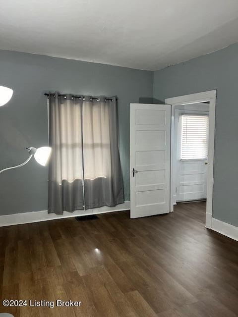 empty room featuring dark wood-type flooring