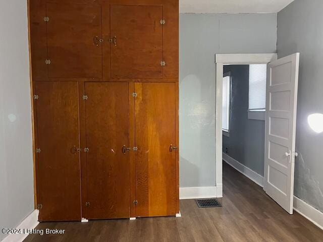 unfurnished bedroom featuring dark hardwood / wood-style floors