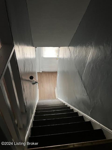 stairs featuring wood-type flooring