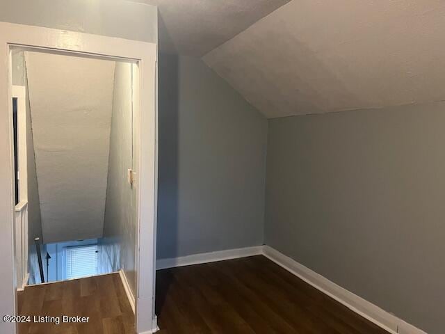 bonus room featuring dark hardwood / wood-style flooring and lofted ceiling