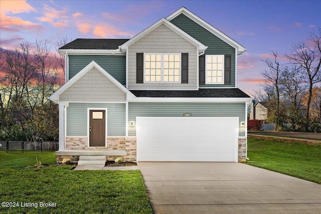 craftsman house featuring a yard and a garage