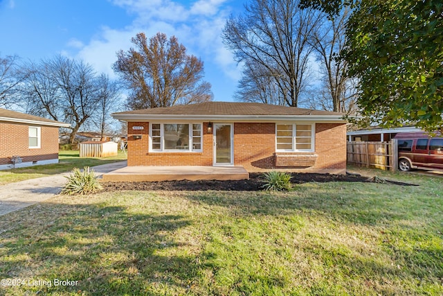 view of front of home with a front yard and a patio