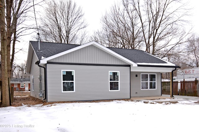 view of snow covered rear of property