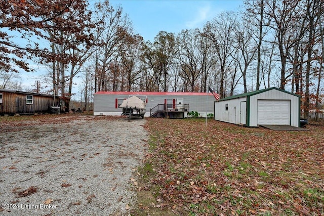 manufactured / mobile home with an outbuilding and a garage