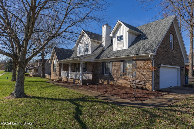 new england style home featuring a porch, a garage, and a front lawn