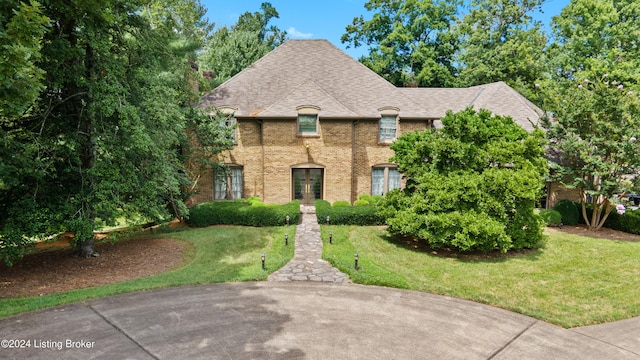 french country style house with a front yard