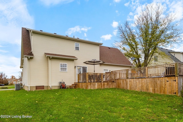 back of house with central AC unit, a lawn, and a wooden deck