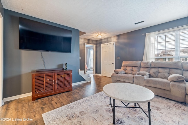 living room featuring hardwood / wood-style flooring and a textured ceiling