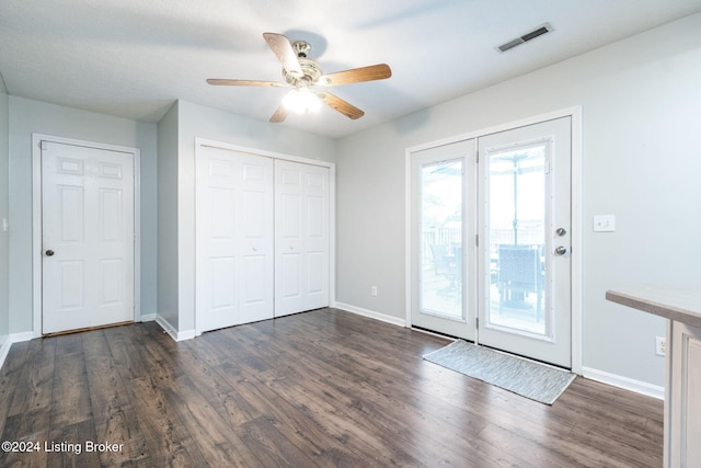 interior space with ceiling fan and dark wood-type flooring