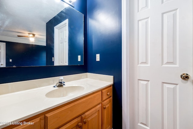 bathroom featuring a textured ceiling, vanity, and ceiling fan