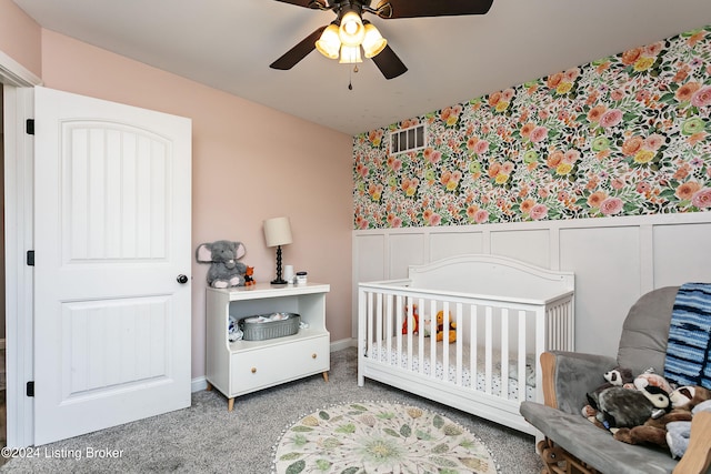 bedroom with carpet, a nursery area, and ceiling fan