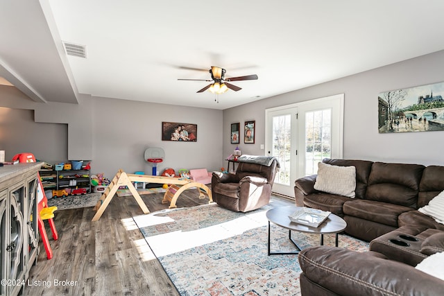 living room with hardwood / wood-style flooring, ceiling fan, and french doors