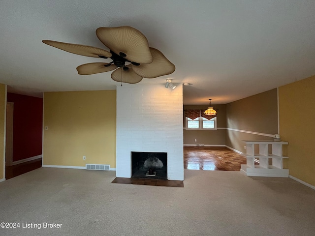 unfurnished living room featuring carpet, ceiling fan, and a fireplace