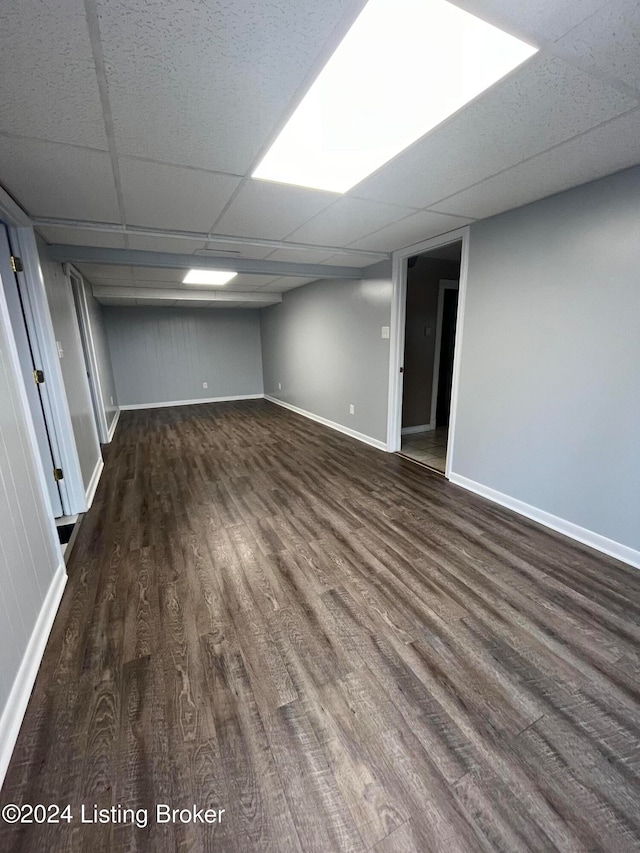 basement featuring dark hardwood / wood-style flooring and a paneled ceiling