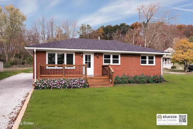 ranch-style home with a deck and a front lawn