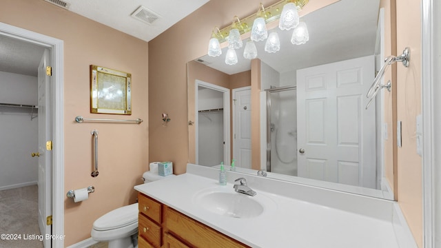 bathroom with vanity, toilet, and an enclosed shower