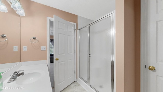 bathroom featuring sink and a shower with shower door